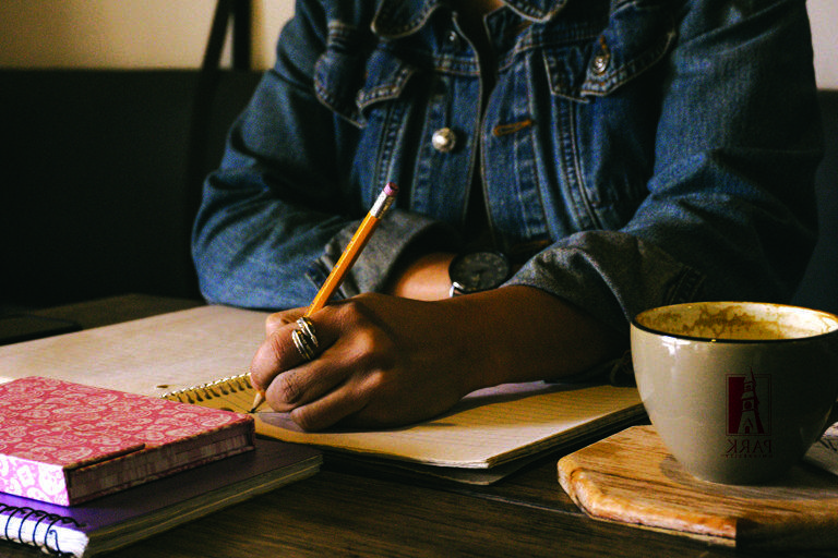 student writing at desk